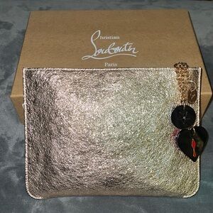 Preloved Christian Louboutin pouchette rose gold color with vintage charms